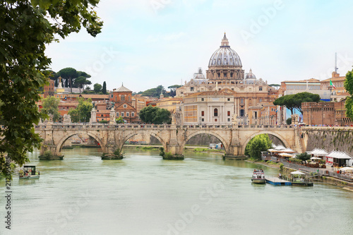 Ponte Sant' Angelo with St. Peter's Basilica in background across Tiber river in Rome, Italy