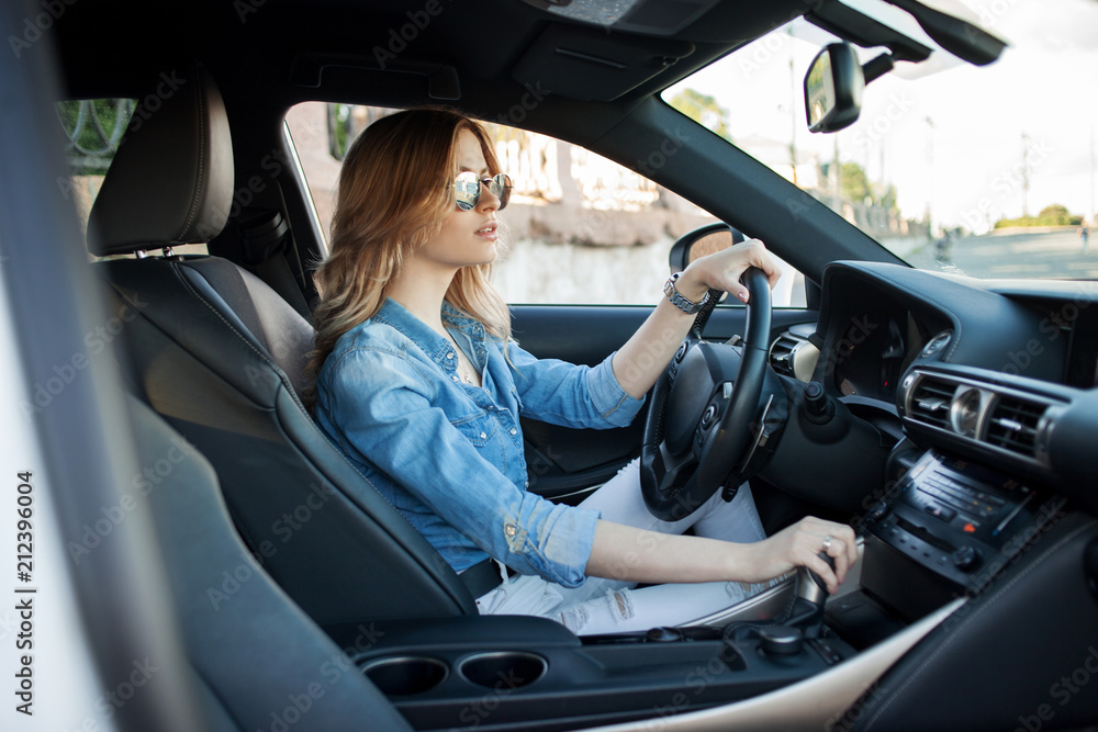 Young attractive woman driving her car. Portrait of a successful business woman