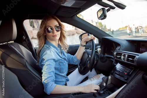 Young attractive woman driving her car. Portrait of a successful business woman © Ulia Koltyrina