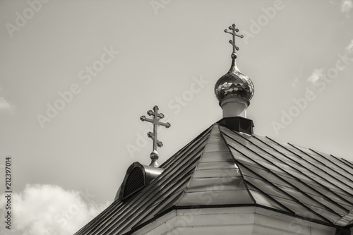 Christian crosses on the roof of the monastery. Religious architecture. Monochrome.