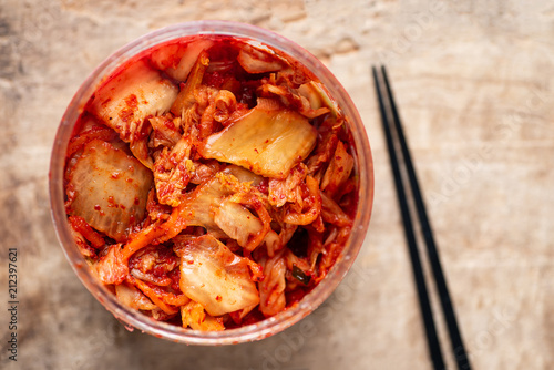 Kimchi cabbage in a bowl with chopsticks for eating, Korean food