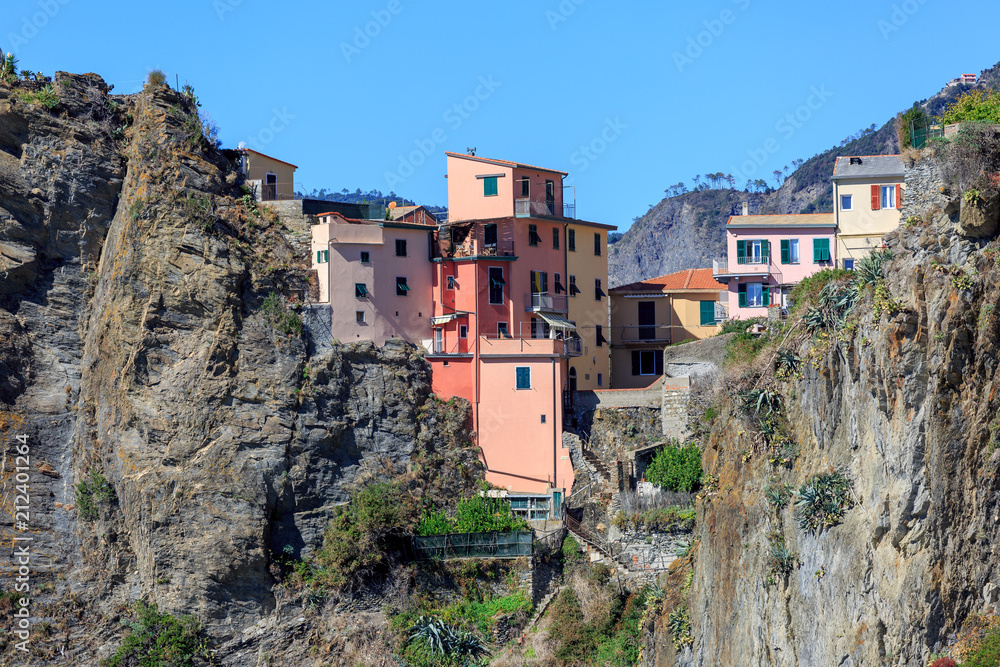 Coastal village scenery in Italy with houses of the Vernaza settlement sticking out above the rocks