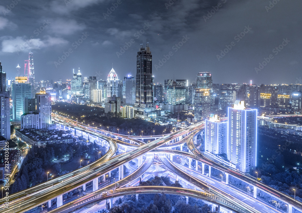 Fototapeta widok z lotu ptaka budynków i węzła autostradowego w nocy w Szanghaju