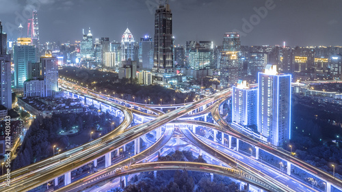 aerial view of buildings and highway interchange at night in Shanghai city