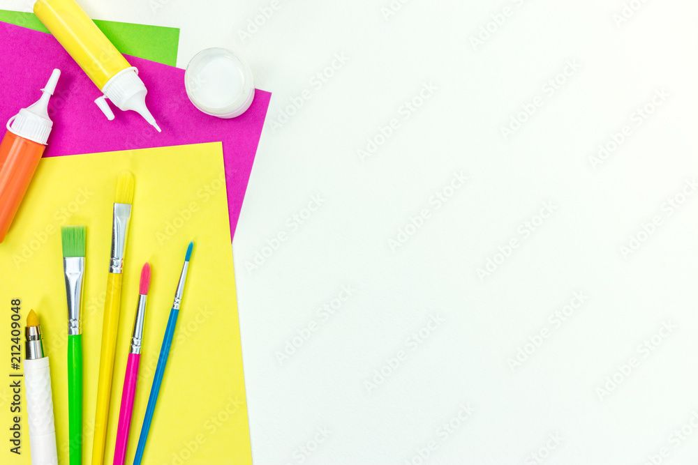 Fototapeta premium school stationary set – brushes, colored paper, watercolor paints on white background with copy space