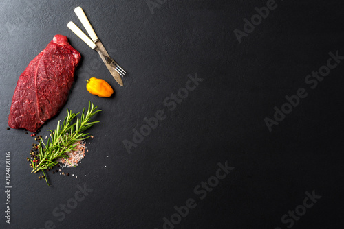 Raw beef steak with herbs and spices. Close up