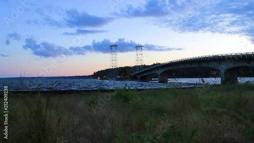 pan on beach under bridge at night photo