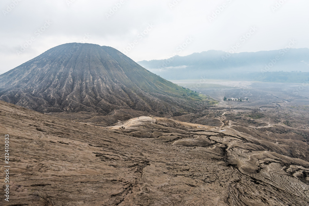 Naklejka premium view of Mount Bromo under cloudy sky with the sand sea
