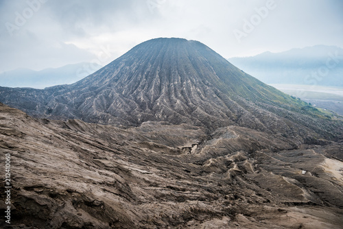 view of Mount Bromo under cloudy sky with the sand sea