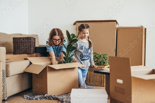 Woman and her daughters moving in new home photo