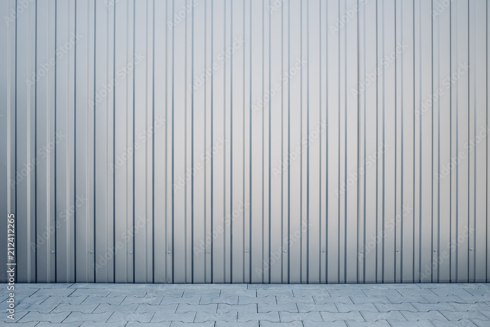 Fototapeta premium Light gray shiny metal exterior wall in the car parking as background texture