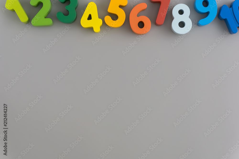 Flat lay composition with numbers wooden baby toy on color background.Top view, copy space Flat lay composition with numbers wooden baby toy on color background.Top view, copy space