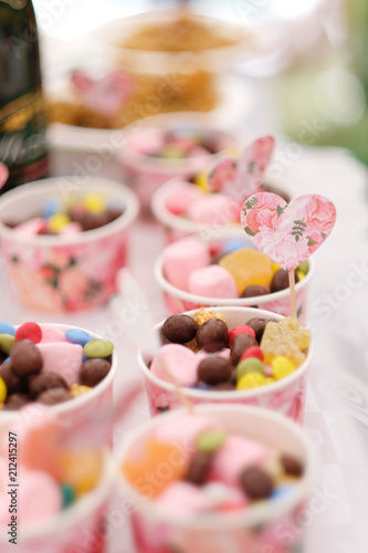 Cups filled with sweets on the table at a children's party