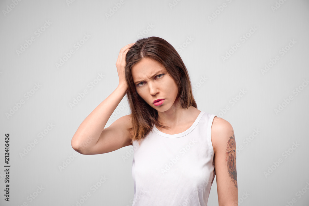 Why is that. Beautiful female half-length portrait isolated on white studio backgroud. Young emotional sad, frustrated and bewildered woman. Human emotions, facial expression concept Why is that. Beautiful female half-length portrait isolated on white studio backgroud. Young emotional sad, frustrated and bewildered woman. Human emotions, facial expression concept