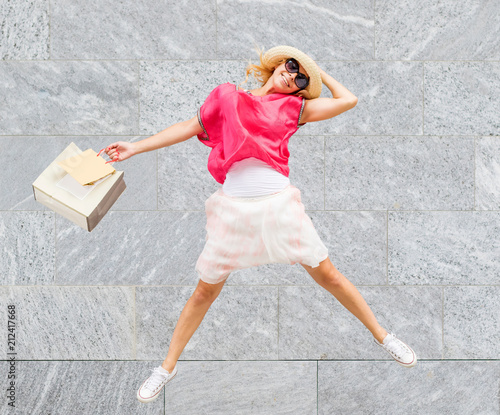 happy woman jump with shopping bag