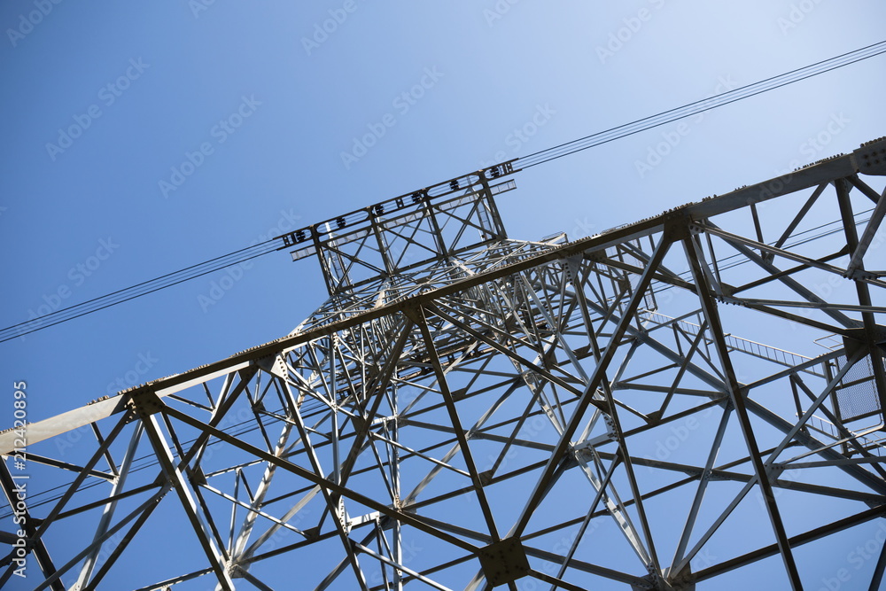 Looking up ropeway pylon against blue sky Looking up ropeway pylon against blue sky