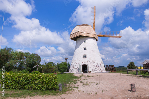 Old windmills and nature, green grass and blue sky. photo