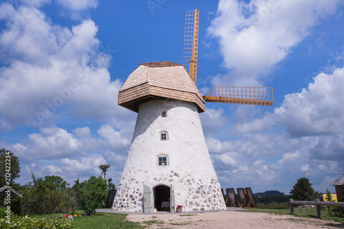 Old windmills and nature, green grass and blue sky. photo