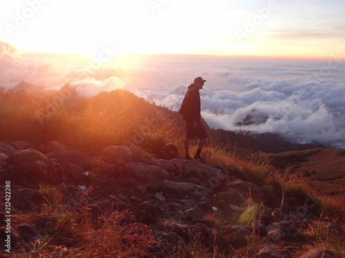 Man on mountain over clouds at Mount Rinjani Volcano Trekking Indonesia