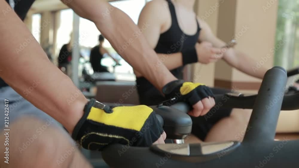 Hard Working Young Athlete Trains on Spinning Exercise Bike Hard Working Young Athlete Trains on Spinning Exercise Bike