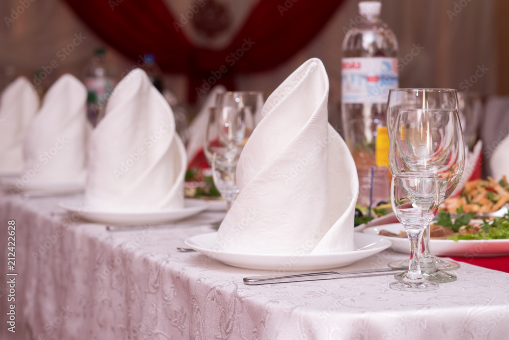 large festive table. glasses of wine. napkins. large festive table. glasses of wine. napkins.