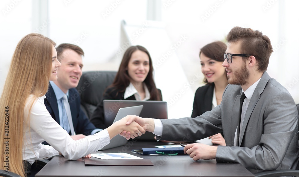 handshake between a businesswoman and a businessman handshake between a businesswoman and a businessman