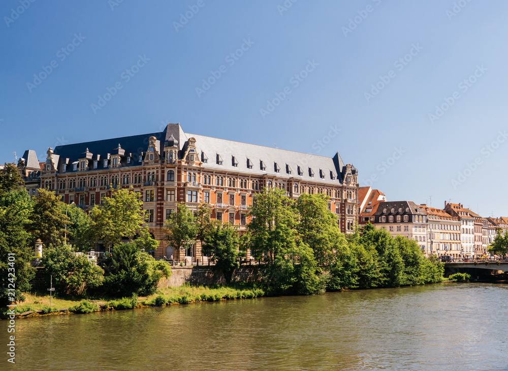 La Gallia majestic building with the Ill river flowing on a warm summer day in Strasbourg, France. Gallia is a building related to Students and Strasbourg University