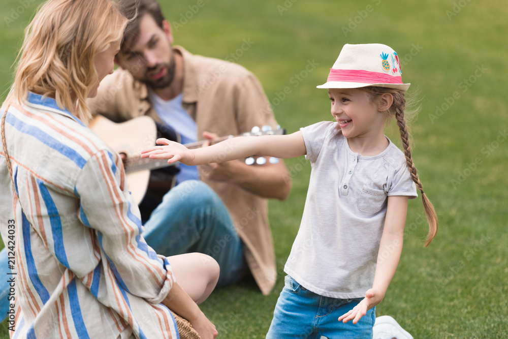 happy family with one child spending time together in park