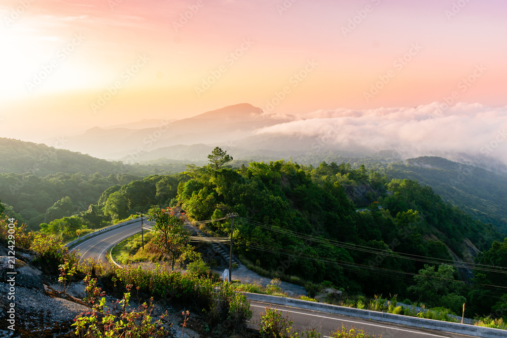 mountain view and sunrise the forest with road on the morning at Doi Inthanon National Park, Chiang Mai, Thailand.