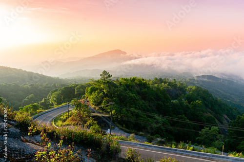 mountain view and sunrise the forest with road on the morning at Doi Inthanon National Park, Chiang Mai, Thailand.