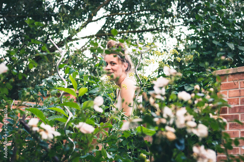 beautiful young woman in her green natural garden