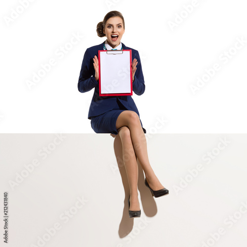Businesswoman Is Sitting On A Top, Showing Clipboard And Talking