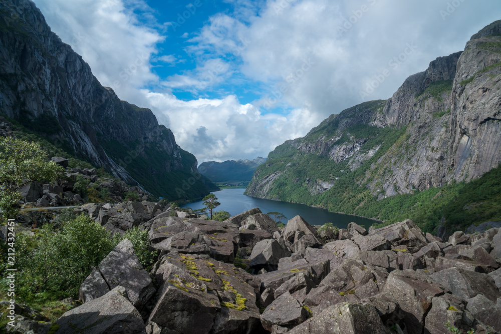 massive fjord in norway with stones infront