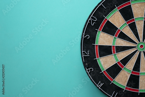 Target dart board on the green background, center point, head to target marketing and business concept