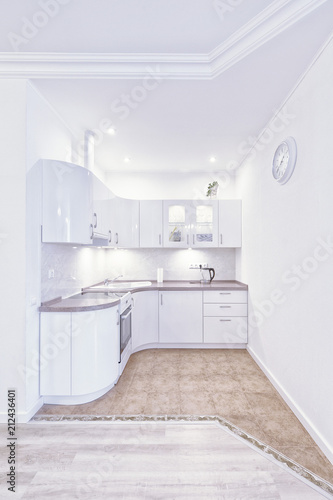 Interior of modern kitchen in white.