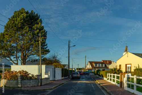 Country houses with fences and streets in the region of Normandy, France. Beautiful countryside, lifestyle and typical french architecture, european country landscapes