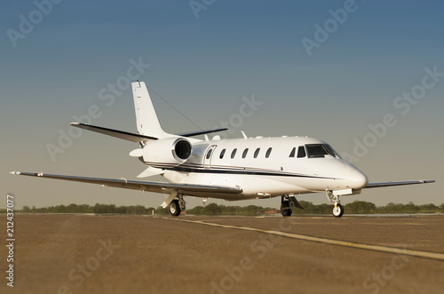 Modern private business jet ready to take off with blue sky at the background