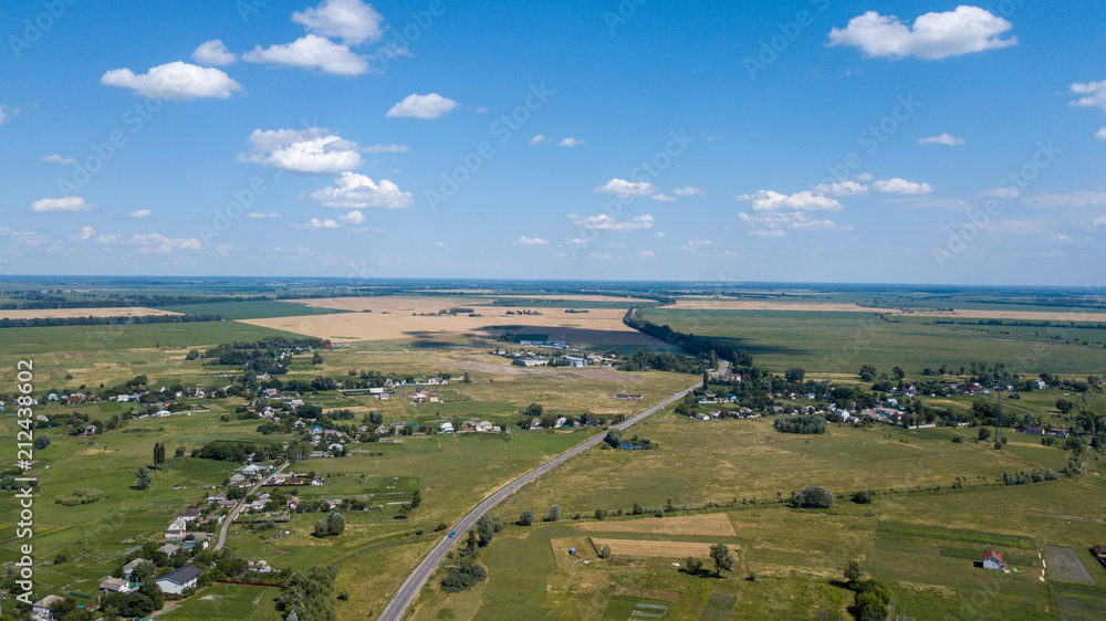 Naklejka premium aerial view of a house in a scenic countryside hills on a sunny day