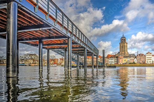 Low view across the IJssel river towards the city of Deventer, The Netherlands and the new ferry pier, constructed on the location of the historic pontoon bridge photo