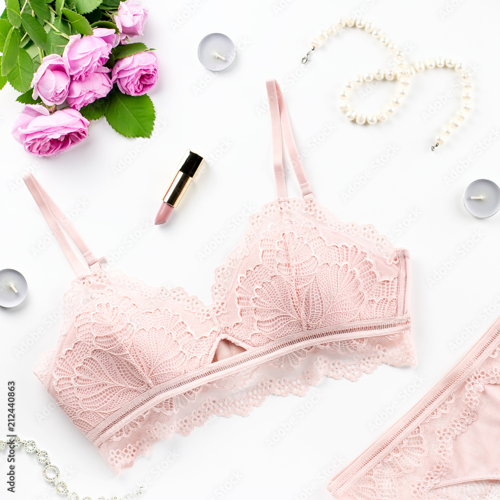 Woman elegant pink lace bra and panties, flowers, jewelry. Stylish lingerie flat lay. Underwear fashion concept Woman elegant pink lace bra and panties, flowers, jewelry. Stylish lingerie flat lay. Underwear fashion concept