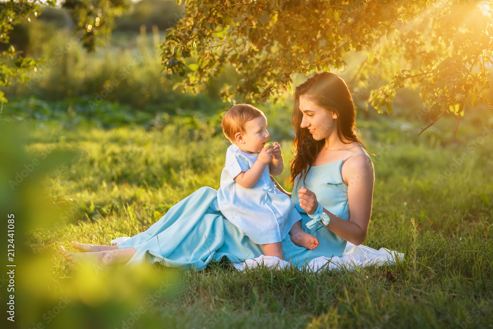 Fototapeta premium mother with little daughter playing on green grass