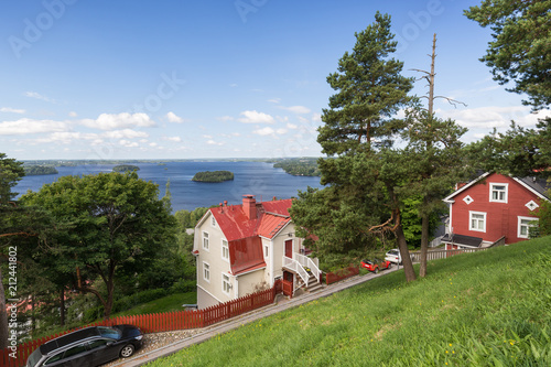 Fotografie Scenic view of two old wooden houses at the Pispala district and Lake Pyhäjärvi from above in Tampere, Finland, on a sunny day in the summer