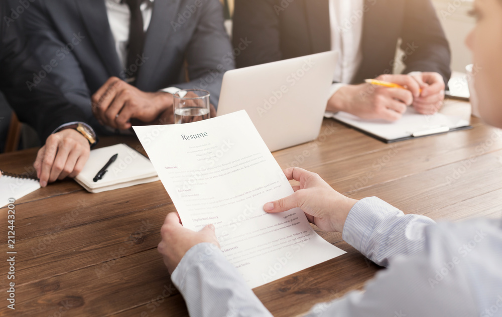 Female candidate holding resume during interview Female candidate holding resume during interview