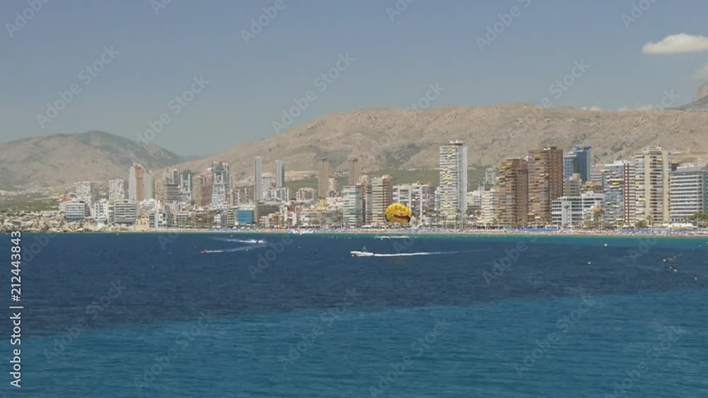 Parasailing on sea coast city skyline background Parasailing on sea coast city skyline background