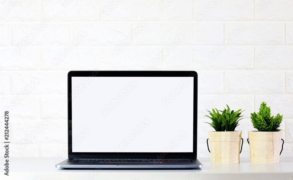 mock up Blank Laptop screen with Green plants on white room brick wall mock up Blank Laptop screen with Green plants on white room brick wall