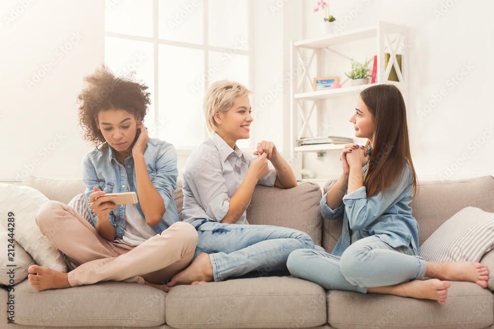 Three female friends relaxing at home