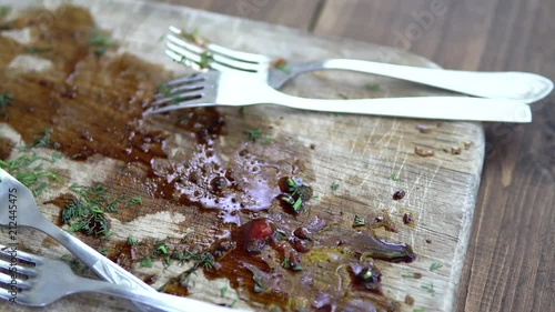 Dirty forks on a dirty wooden board after cooking. Clouse-up photo