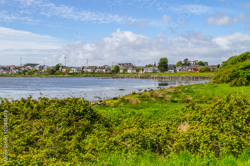 Lough Atalia bay with houses in background and cloud reflection