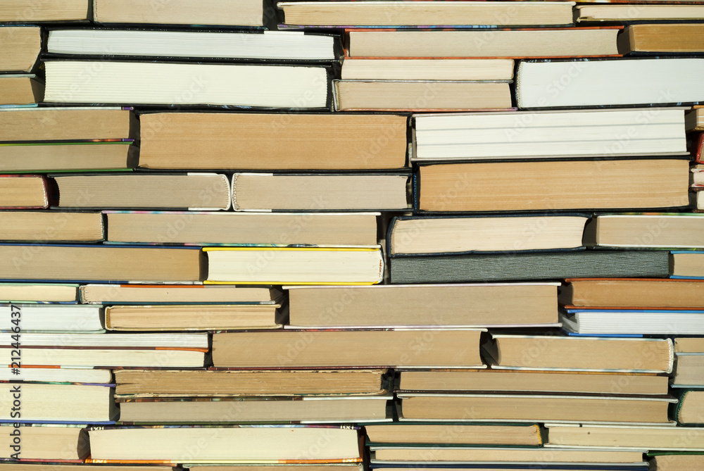 Fototapeta premium background - a wall composed of books of different sizes
