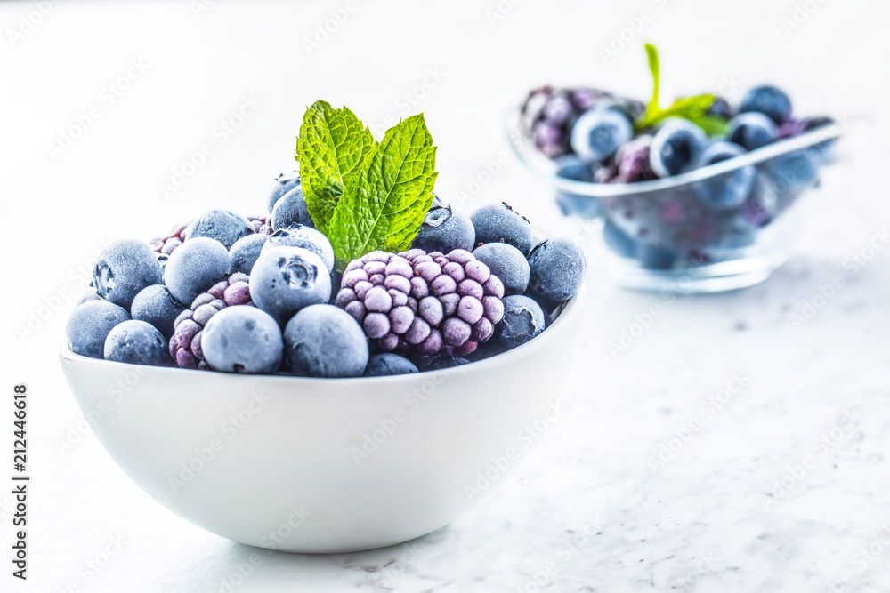 Close-up frozen blueberries and blackberries with mint leaves - obrazy, fototapety, plakaty 